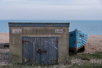 Built structure on beach against sky