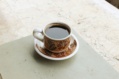 High angle view of coffee cup on table