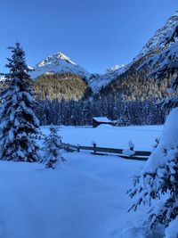 Snow covered mountain against blue sky