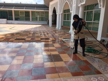 Full length of woman standing in front of building