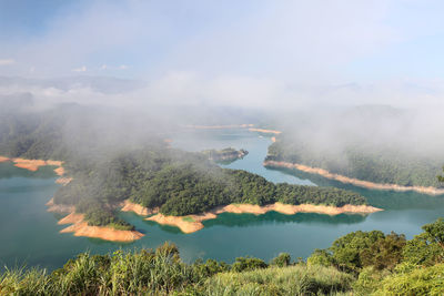 Scenic view of lake and mountains against sky