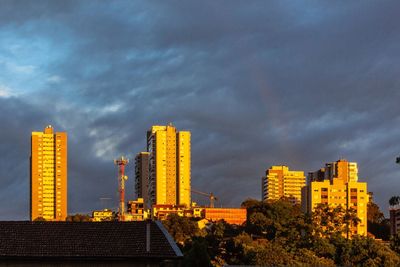 Modern buildings against sky at dusk