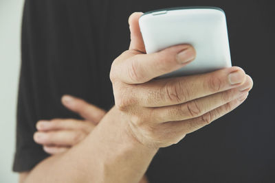 Midsection of man using phone