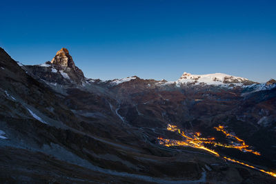 Scenic view of mountains against blue sky