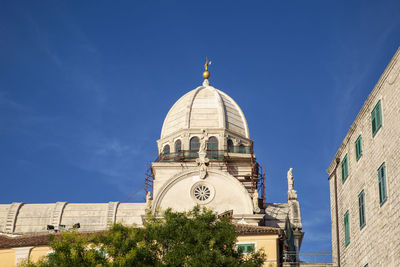 Low angle view of buildings against blue sky