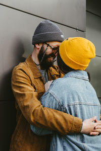 Midsection of man wearing hat standing outdoors