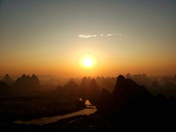 Scenic view of silhouette mountains against sky during sunset