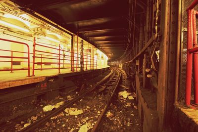 Train at illuminated railroad station at night