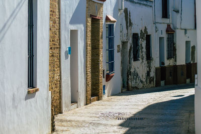 Narrow alley amidst buildings in city