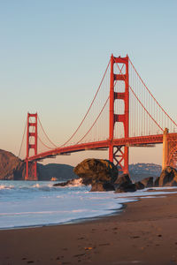 View of suspension bridge against clear sky