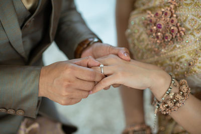 Midsection of bride holding hands