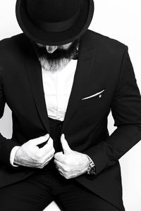 Man wearing blazer while standing against white background