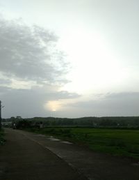 Road by landscape against sky