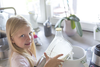 Portrait of smiling girl holding indoors