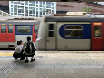 Rear view of people on train at railroad station