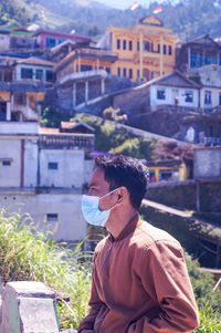 Young man wearing mask when traveling and vacation to indonesia