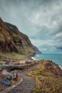 Scenic view of sea and mountains against sky