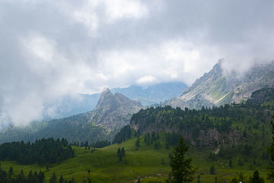 Scenic view of mountains against cloudy sky