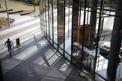 High angle view of people walking on glass window