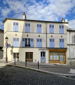 Building by street against sky