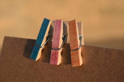 High angle view of multi colored clothespins on table against wall