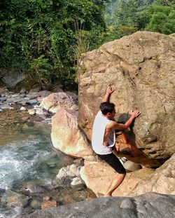 Full length of man climbing on rock