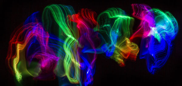 Multi colored light painting against black background