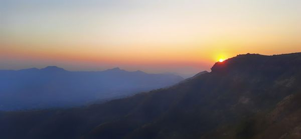 Scenic view of silhouette mountains against sky during sunset