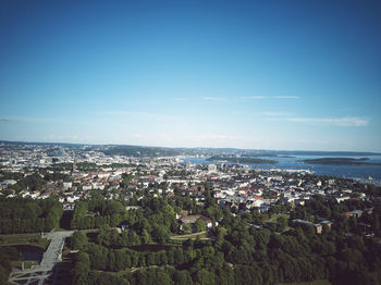 High angle view of townscape by sea against sky