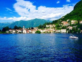 Boats in river with town in background