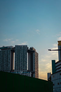 Low angle view of buildings against sky during sunset