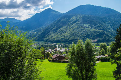 Scenic view of trees and buildings against mountains