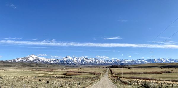 Scenic view of mountains against blue sky