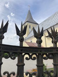 Low angle view of cross against sky