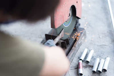 High angle view of man working on metal