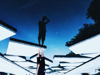 Low angle view of silhouette man against clear sky