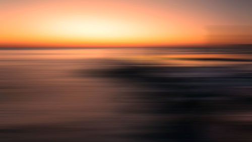 Scenic view of sea against romantic sky at sunset