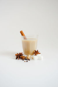 Close-up of drink on glass against white background