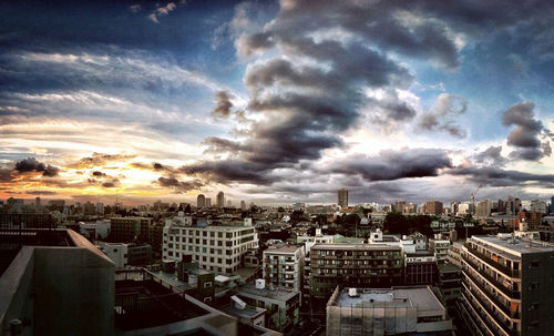 Cityscape against cloudy sky