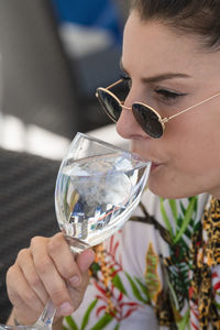 Close-up of woman drinking glass