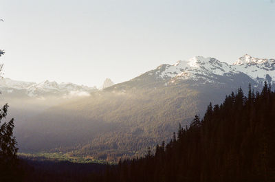 Scenic view of snowcapped mountains against clear sky