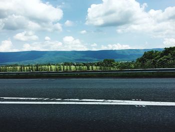 Scenic view of mountains against cloudy sky