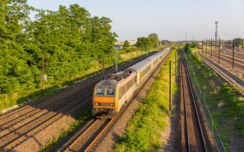 Train on railroad tracks against sky