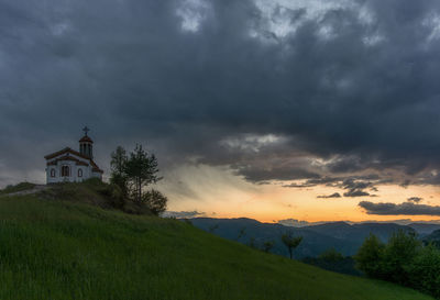 Scenic view of building against sky during sunset