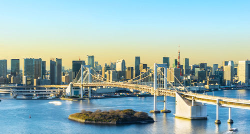 Bridge over river with buildings in background