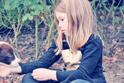 Rear view of girl sitting with horse