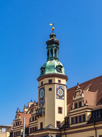 Low angle view of building against clear blue sky