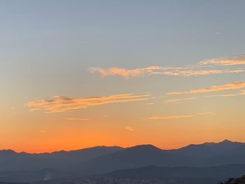 Scenic view of silhouette mountains against sky during sunset