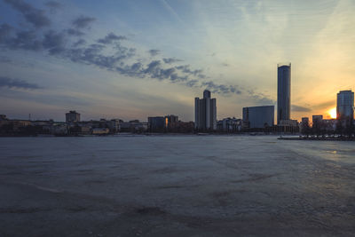 Modern buildings in city at sunset