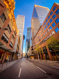 City street amidst buildings against sky